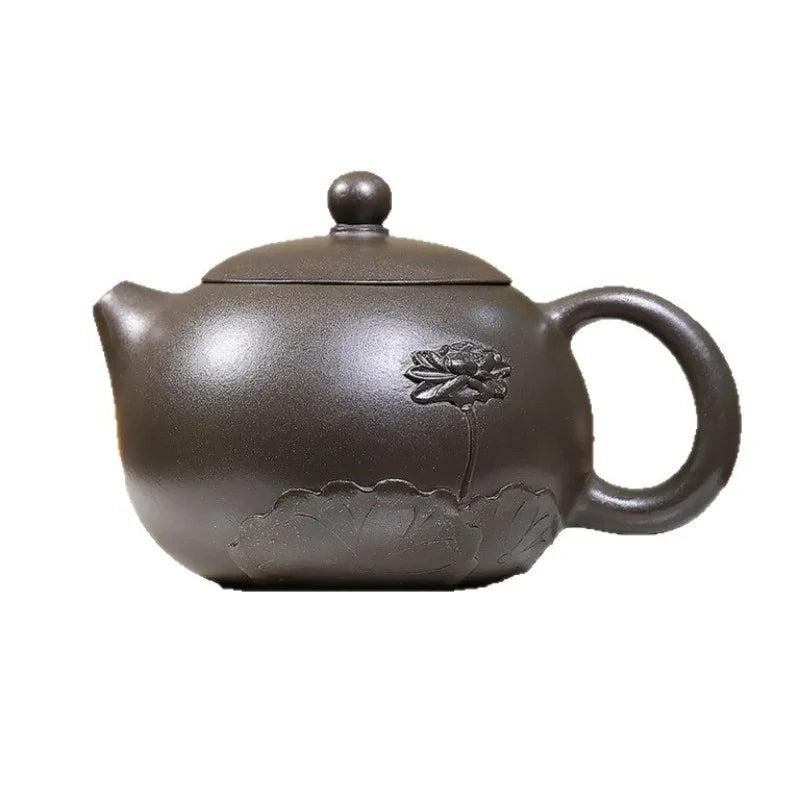 A dark brown ceramic teapot with an embossed lotus flower and leaf design on the side, shown against a plain white background.