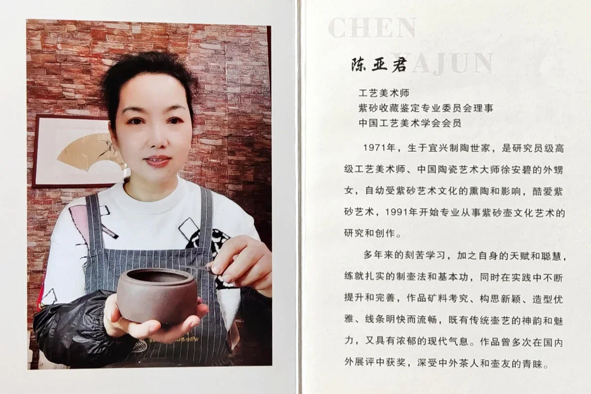 Person holding a ceramic cup and brush with text on the right side