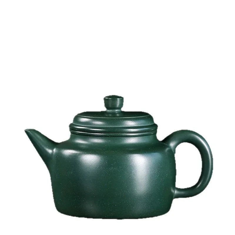 Green ceramic teapot on a white background


